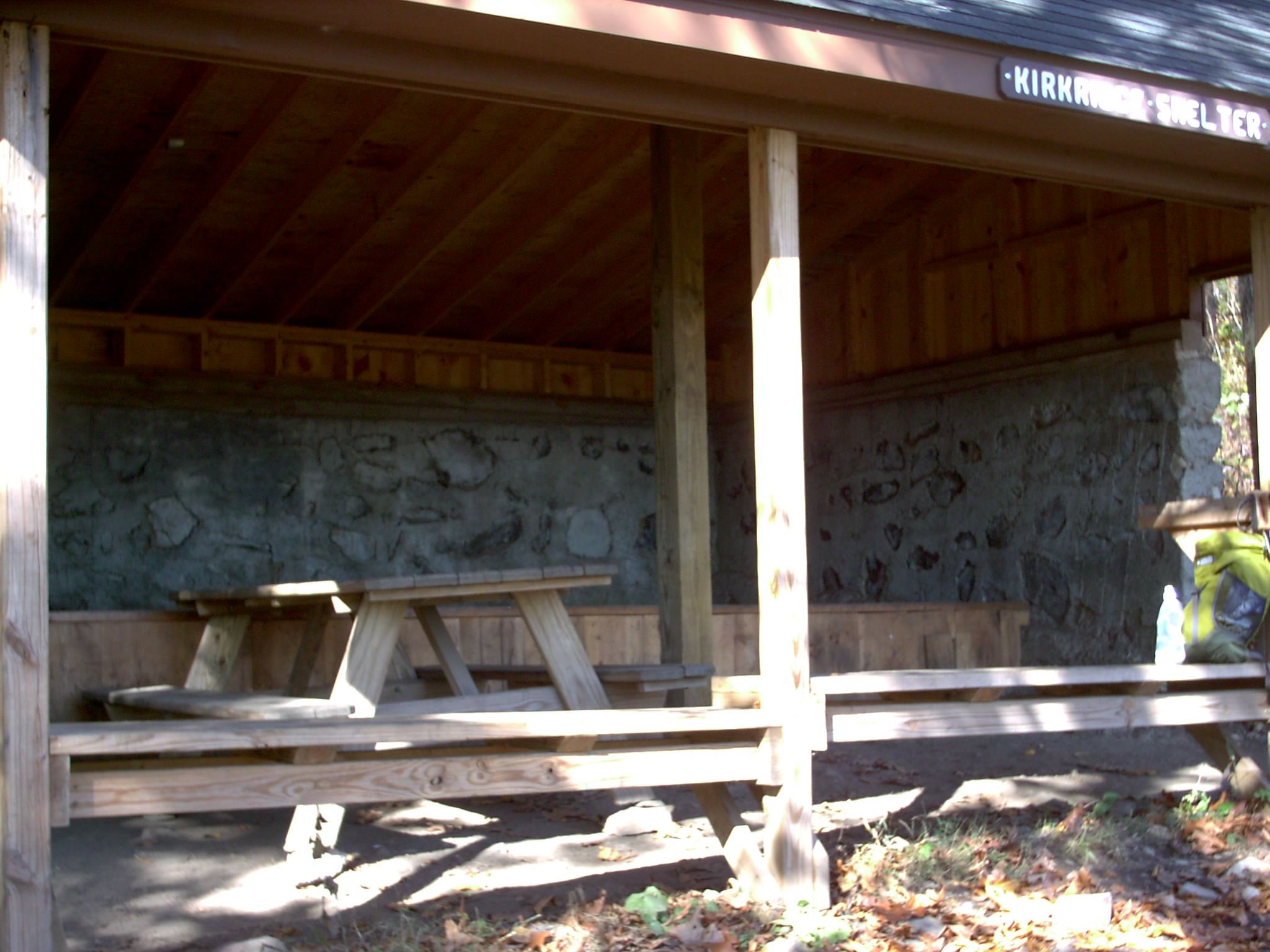 mm 6.5 - The interior of Kirkridge shelter. It is a very new and nicely set-up with a large, high sleeping platform, benches at the front of the large porch, and potable water from the church camp just up the ridge.  Courtesy stewartriley@earthlink.net
